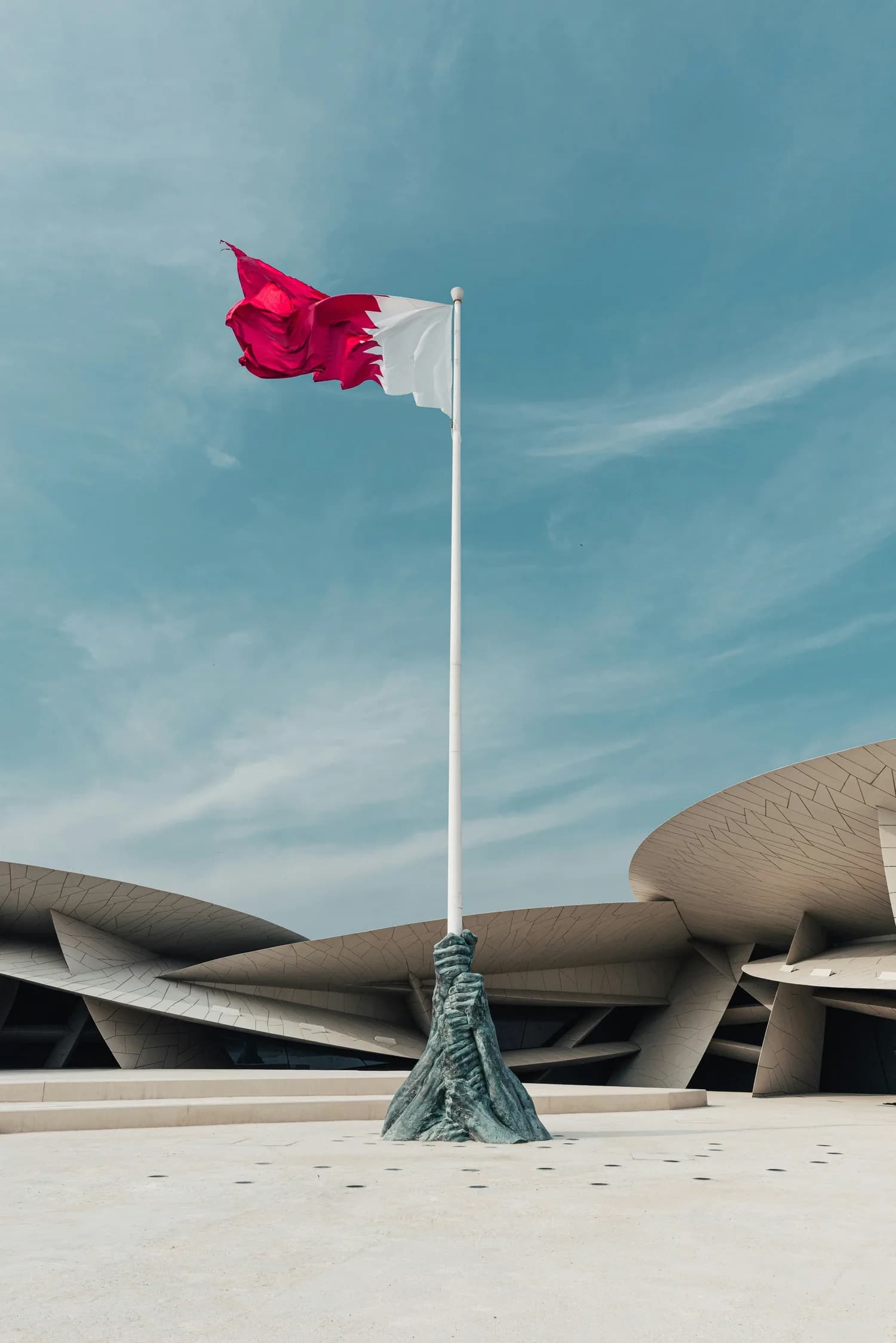 The Qatar flag flying before the National Museum of Qatar, Doha